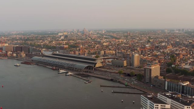 Drone aerial view of Amsterdam NDSM wharf area and ij river during sunset