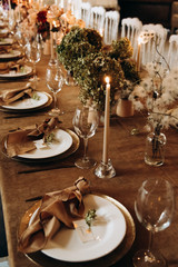 wedding table setting for a dinner with flowers and candles