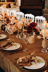 wedding table setting for a dinner with flowers and candles