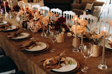 wedding table setting for a dinner with flowers and candles