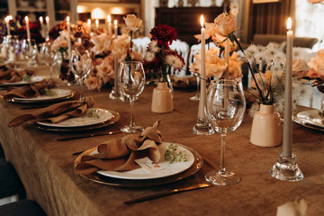 wedding table setting for a dinner with flowers and candles