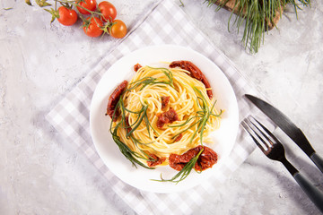 Spaghetti with agretti, a spring vegetable from Italy, and sun dried tomatoes and ingredients and...