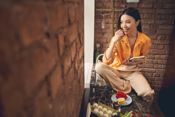 Charming lady looking out the window and smiling