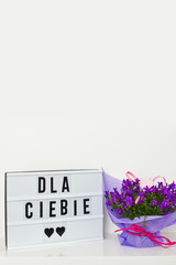 Bouquet of campanula flowers as a gift on white. For You in Polish text.