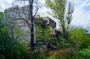 The ruined building. Old reinforced concrete structures. Ruin. The consequences of the war.