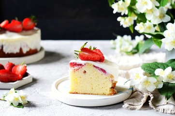Strawberry cake with cream in a plate on a gray background