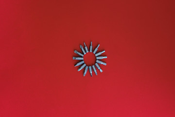 Screwdrivers, bits, construction metal, for repairs on a uniform red background, workspace