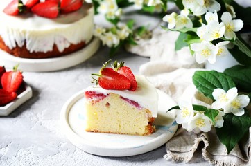 Strawberry cake with cream in a plate on a gray background