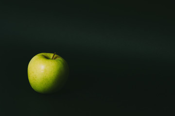 Single apple on black background