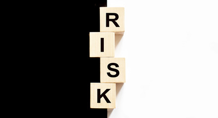 Business concept text on wood block Risk on the black and white background