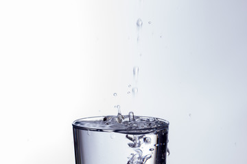 water falling into a clear glass