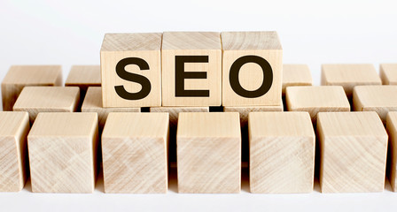 Seo word from wooden blocks on desk, search engine optimization concept