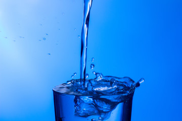 water falling into a clear glass