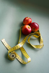 Apples lie together with a measuring tape, a hint of diet, weight loss