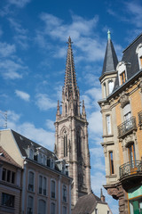 Fototapeta na wymiar retail of traditional architecture in Mulhouse with the protestant temple on background