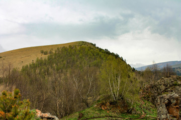 Spring comes in the mountains in the Caucasus. clouds over the mountains, rain is expected.