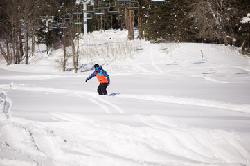 Snowboarder silhouette in ski resort, skiing in the mountains