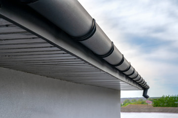 . Gutter system for a metal roof. Holder gutter drainage system on the roof.