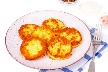 Vegetable marrow pancakes with white sauce. Photo