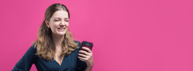 Obraz na płótnie Canvas Glamor woman with a drink of coffee on a pink background