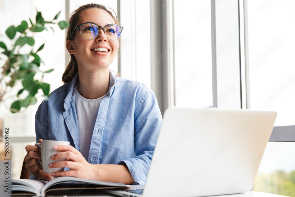 Sticker Image of woman working with laptop and drinking tea while sitting