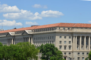 Fototapeta na wymiar Washington DC, Department of Commerce Building with waving US flag