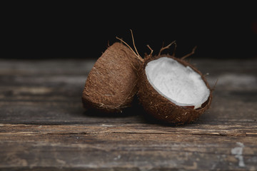 Ripe half cut coconut on a wooden background. Ripe half cut coconut on a wooden background. Coconut...