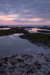 Photo of still waters at sunset near Tanah lot temple in Bali
