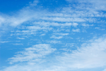 Snow-white light cumulus clouds against a blue sky