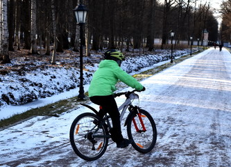 A child rides a Bicycle in a winter Park