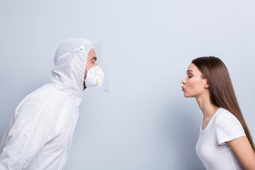 No kisses no hugs. Profile photo of patient lady guy doc virology clinic couple dates stand opposite want kiss wear mask hood uniform plastic facial protection isolated grey color background