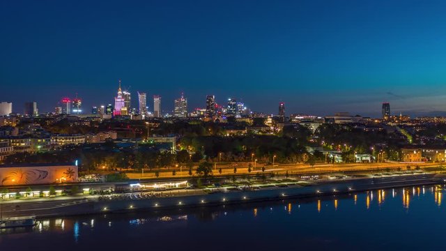 panorama timelapse of night Warsaw city centre over Wisla river in Poland