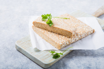 Slice of tempeh  or tempe made of fermentation process that binds soybeans, is traditional food...