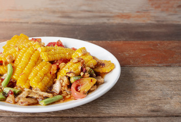 green papaya salad(Som Tam Thai) Corn Salad (Tam corn in black plate on wooden background.