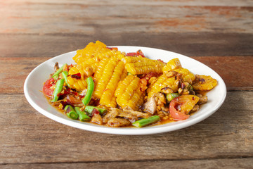 green papaya salad(Som Tam Thai) Corn Salad (Tam corn in black plate on wooden background.