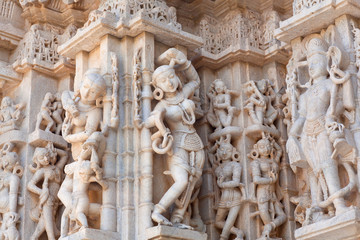 Ancient bas-relief with dancing Apsara and Surasundaris of famous Neminath Jain temple in Ranakpur, Rajasthan, India