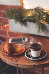 cup of coffee on the table croissant