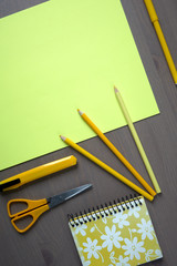 Desk with yellow stationery. Wooden desk tidy with all office objects.