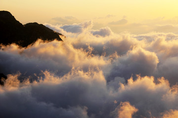 Above the clouds, mountain and cloudy scape