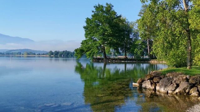 green park and blue lake near a lake in Switzerland. Perfect location for Yoga lifestyle