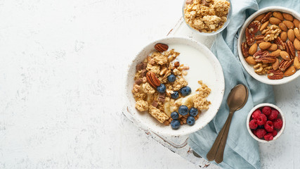 Fototapeta na wymiar Yogurt with Granola. Breakfast, healthy diet food with oat flakes, nuts