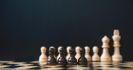 chess pieces on a chessboard on a black background