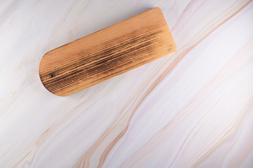 Wooden cutting board on a gray marble background
