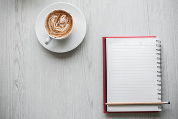 Top view of Laptop or Notebook Computers , pencil , and cup of coffee on white wooden table.