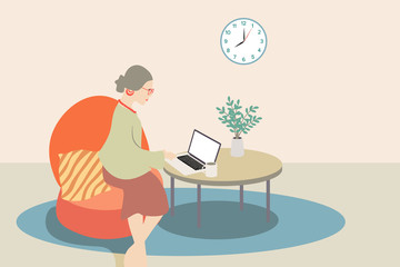 Beautiful retro woman comfortably working from home, sitting on couch with laptop and cup on the table.