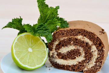 Tasty, sweet cake for breakfast, close-up. It can be served with tea with lime and mint. Food for lovers of sweets.