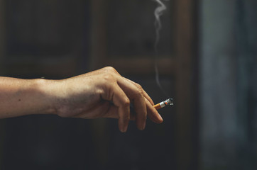 Human hand holds the cigarette