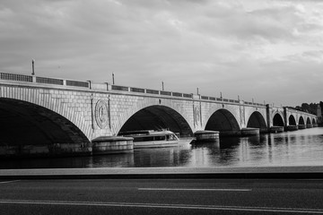 Memorial Bridge and a pleasure boat in motion blur riding in Potomac River - Washington D.C. United...