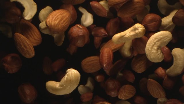 Nuts are tossed in the Air in Slow Motion