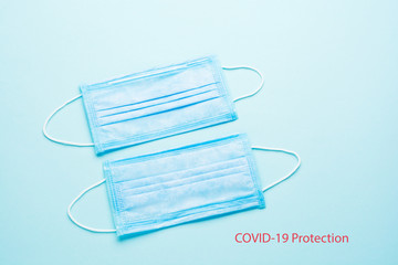 Blue Medical Disposable Face Mask with covid-19 printed on it. Coronavirus pneumonia gets official name from WHO: COVID-19. Disposable breath filter face mask with earloop.